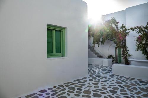 a white building with a window and ailed floor at ZIMARAKI Houses in Chora Folegandros