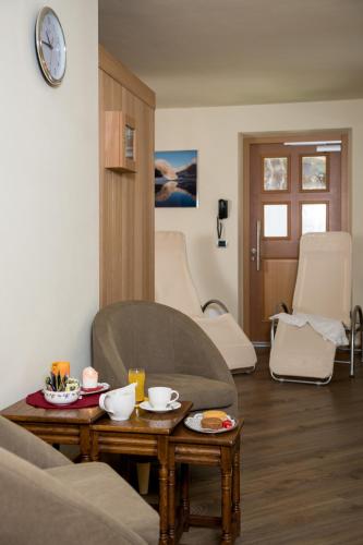 a living room with a couch and a coffee table at Garnì Val de Grepa in Pozza di Fassa