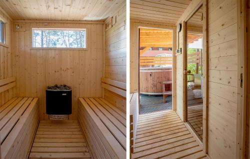 a wooden sauna with a stove and a window at Nice Apartment In Ostrowite With Sauna in Ostrowite
