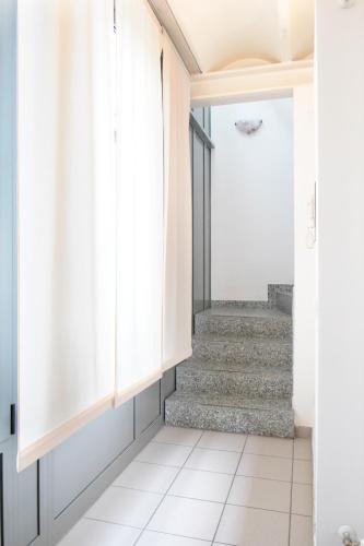 a hallway with stairs in a house at Appartamenti tra Lago e Montagna CASA IDEALE LECCO in Lecco