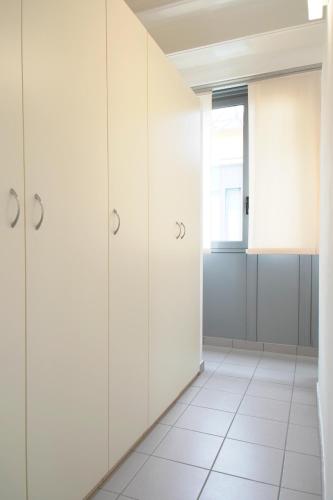 a room with white cabinets and a window at Appartamenti tra Lago e Montagna CASA IDEALE LECCO in Lecco