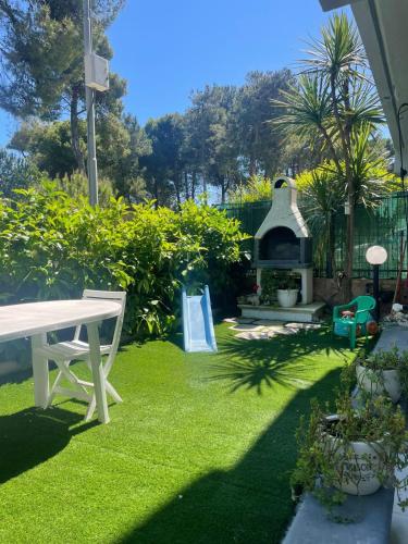 a garden with a picnic table and a playground at A due passi dal mare in Montesilvano