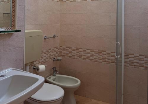 a bathroom with a toilet and a sink and a shower at Hotel Riviera Nuova Gestione in Cattolica