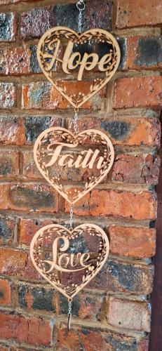 two heart signs hanging on a brick wall at French Toast in George