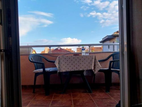 a table and chairs on a balcony with a view at Sorin Apartments Gevgelija in Gevgelija