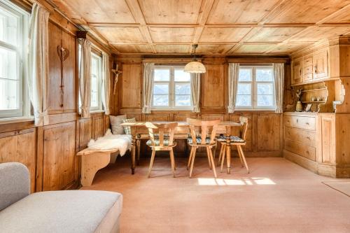 a kitchen with a table and chairs in a room at Chalet Zimbablick in Bartholomäberg