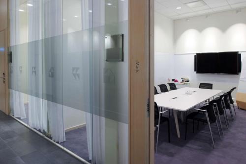 a conference room with a white table and chairs at Scandic Victoria Tower in Stockholm