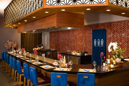 a long dining room with a long table and blue chairs at Da Nang - Mikazuki Japanese Resorts & Spa in Da Nang