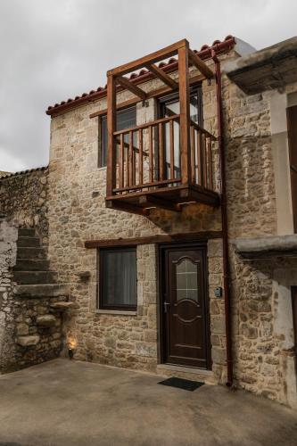 a balcony on the side of a building with a door at Orion Homes & Villas in Choudetsi
