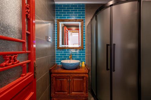 a bathroom with a sink and a mirror at Beijing city center - Courtyard house hotel located in an ancient Hutong, near the Forbidden City,experience the lifestyle of old Beijing in the exquisite Chinese-style courtyard in Beijing