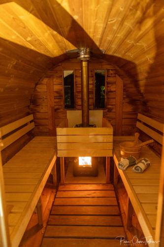an inside view of a wooden cabin with a fireplace at Le Jardin Secret in Waterloo