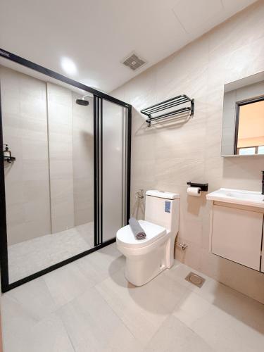 a bathroom with a shower and a toilet and a sink at Resandau Stay Ipoh - Nearby Ipoh Town - Private Car Park and Lift - Whole unit & Coliving in Ipoh