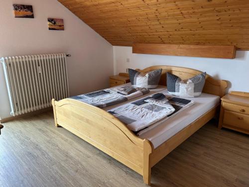 a bedroom with a large wooden bed in a room at Ferienwohnung Stefanie in Hagnau