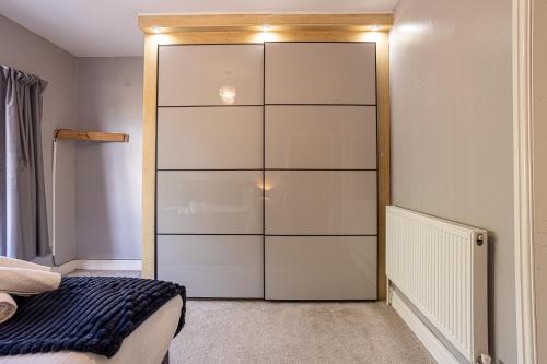 a bedroom with a large white closet at Newly Refurbed 5 Bed House for Contractors, Families & Relocation- Cosely Wolverhampton in Coseley