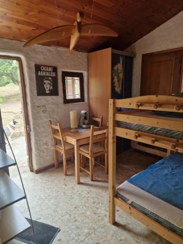 - une chambre avec une table et des lits superposés dans l'établissement U Cipressu, à Olmeto