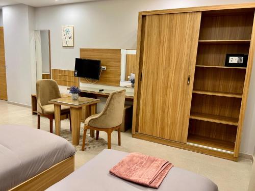 a hotel room with a bed and a desk with a computer at Elite hotel in Sheikh Zayed