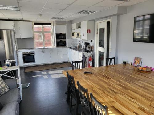 a kitchen and dining room with a wooden table at kämpagatans bed and breakfast in Skara