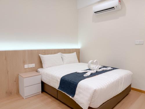a bedroom with a bed with a towel on it at Resandau Stay Ipoh - Nearby Ipoh Town - Private Car Park and Lift - Whole unit & Coliving in Ipoh