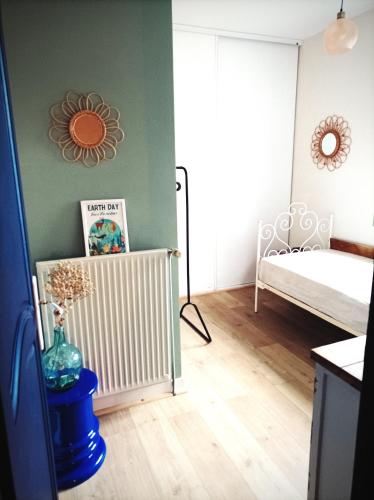 a room with a bedroom with a bed and a mirror at Maison familiale campagne piscine forêt in Saint-Chamond
