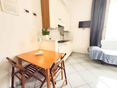 a small kitchen with a table and chairs in a room at Excelsior Mare Suite in Ischia