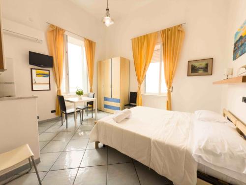 a bedroom with a bed and a table and a desk at Excelsior Mare Suite in Ischia