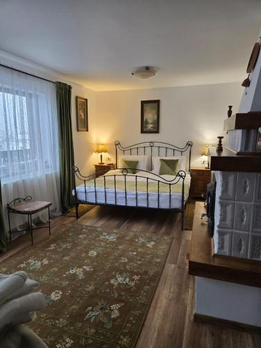 a bedroom with a bed and a rug at DRUMUL DOMNISORILOR c in Buşteni