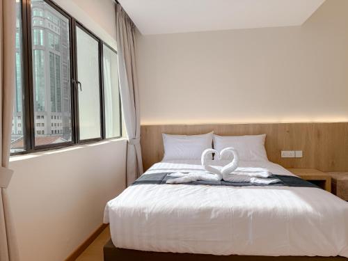 a bedroom with a bed with a heart decoration on it at Resandau Stay Ipoh - Nearby Ipoh Town - Private Car Park and Lift - Whole unit & Coliving in Ipoh