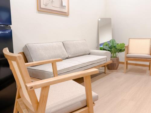 a living room with a couch and a chair at Resandau Stay Ipoh - Nearby Ipoh Town - Private Car Park and Lift - Whole unit & Coliving in Ipoh