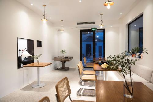 a living room with a dining room table and chairs at My Home in Shanghai