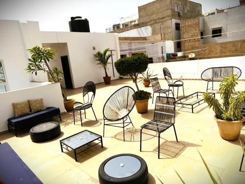 a patio with chairs and tables on a building at La Maison des Couleurs in Dakar