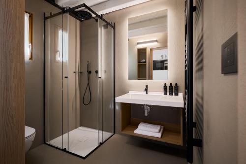 a bathroom with a shower and a sink and a toilet at Colago Private Villas Lake Garda in Toscolano Maderno