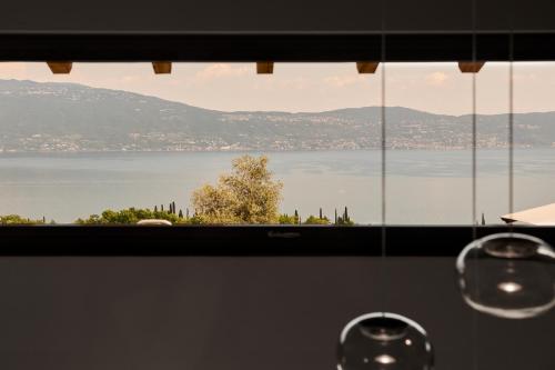a view of the water from a kitchen window at Colago Private Villas Lake Garda in Toscolano Maderno