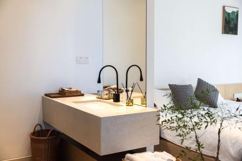 a bedroom with a vanity with a bed and a mirror at My Home in Shanghai
