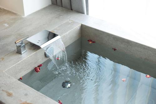 a pool of water with people swimming in it at My Home in Shanghai