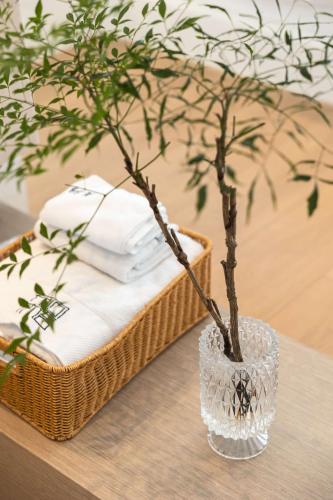 a glass vase with a tree in it on a table at My Home in Shanghai