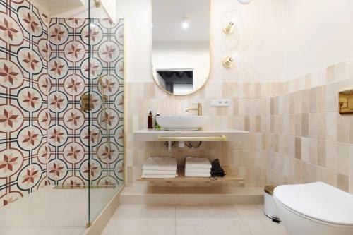 a bathroom with a sink and a toilet at Hetman Main Square Apartments in Krakow