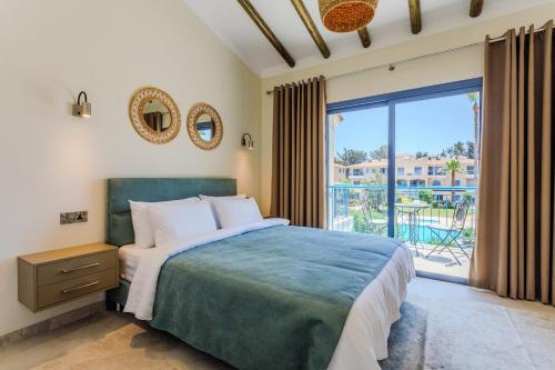 a bedroom with a bed and a large window at All Seasons Boutique Townhouse in Paphos City