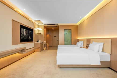 Ένα ή περισσότερα κρεβάτια σε δωμάτιο στο May Joys Hotel
