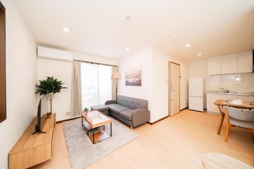 a living room with a couch and a table at GLOU Shibuya House - A Private House in Tokyo Shinjuku & Shibuya Area in Tokyo