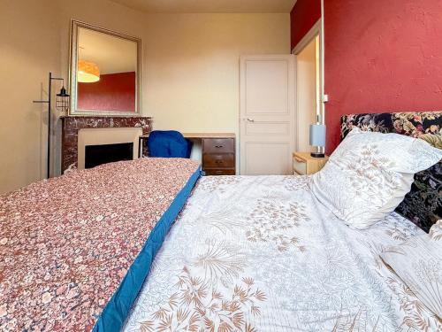 - une chambre avec un lit, une cheminée et un miroir dans l'établissement Gîte Au Coeur de l 'Alllier, à Droiturier