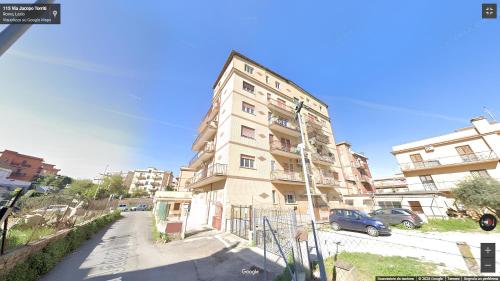a tall apartment building with a car parked in front of it at la casa di jo in Rome