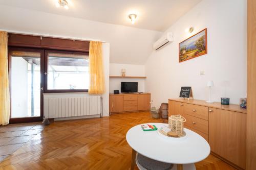 a living room with a white table and a television at Spacious Apartments by the Sea in Srima, Vodice in Srima