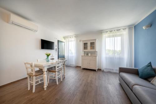 a living room with a table and a couch at Appartamenti Alla Lanterna in Costermano sul Garda