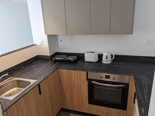 a kitchen with a sink and a counter top at Sunflower Hotel Apartments in Larnaka