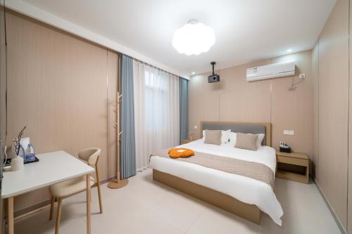 Postel nebo postele na pokoji v ubytování Shanghai nanfeng hotel-上海楠枫花园酒店