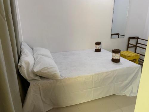 a bed with two pillows on it in a room at Beauty City Hotel in Dambulla