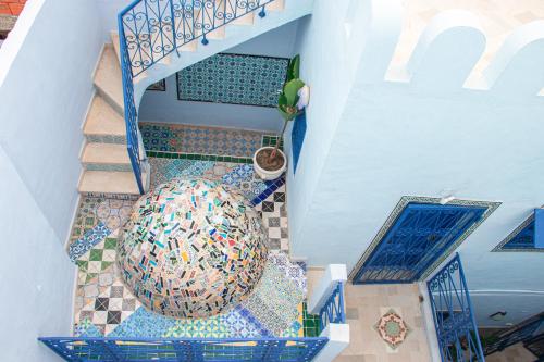 an overhead view of a staircase with a mosaic floor at Dar Shams Riad Medina de Sousse in Sousse