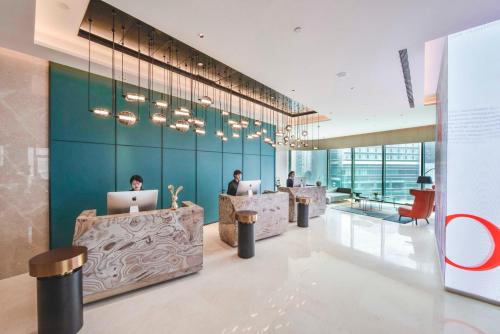 a lobby with people working on their laptops at Mustel in Chengdu