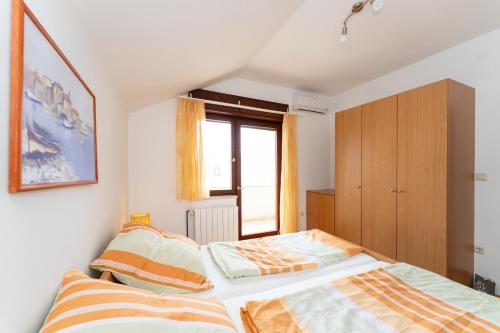 a bedroom with two beds and a window at Spacious Apartments by the Sea in Srima, Vodice in Srima