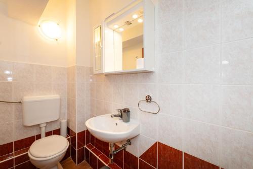 a bathroom with a toilet and a sink at Spacious Apartments by the Sea in Srima, Vodice in Srima